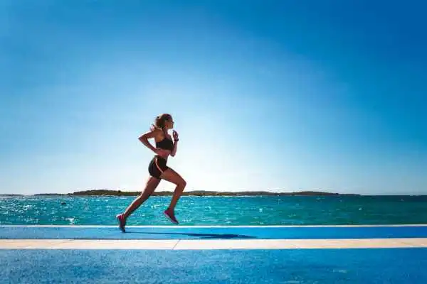 Woman running showing strong leg muscle Halstead